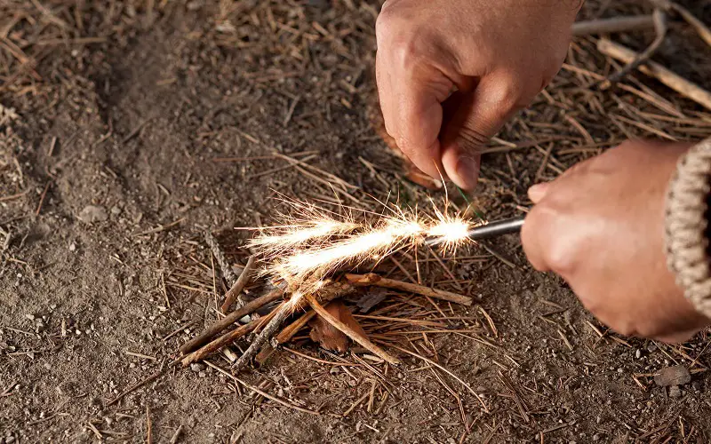 Using ferro rod to start a campfire