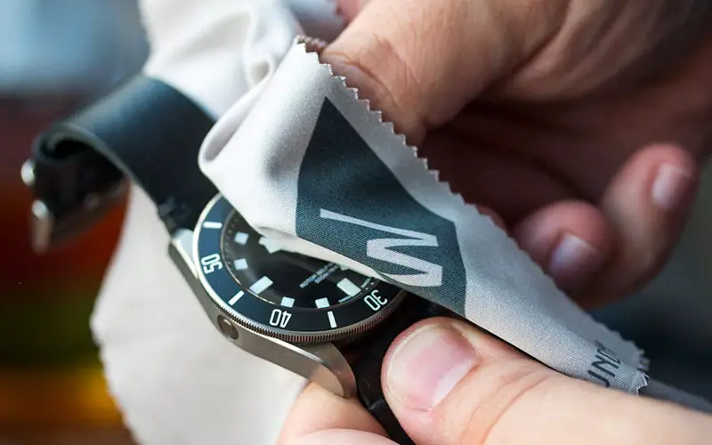 Cleaning fishing watch with cotton cloth