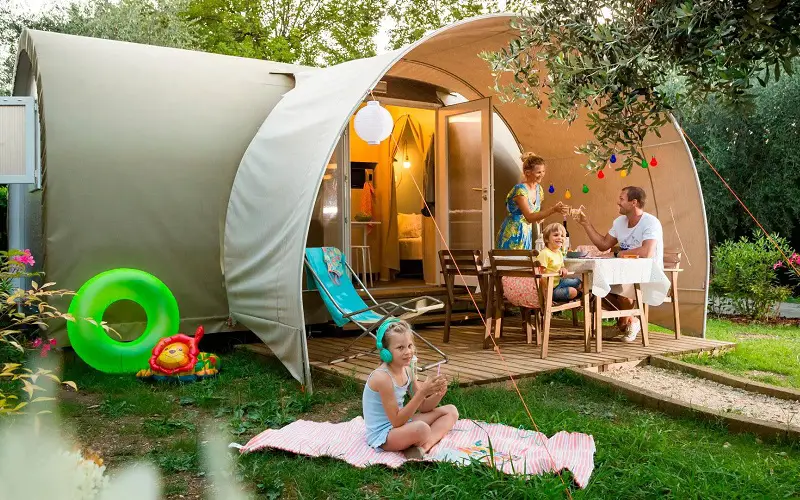 Family camping inside luxury tent