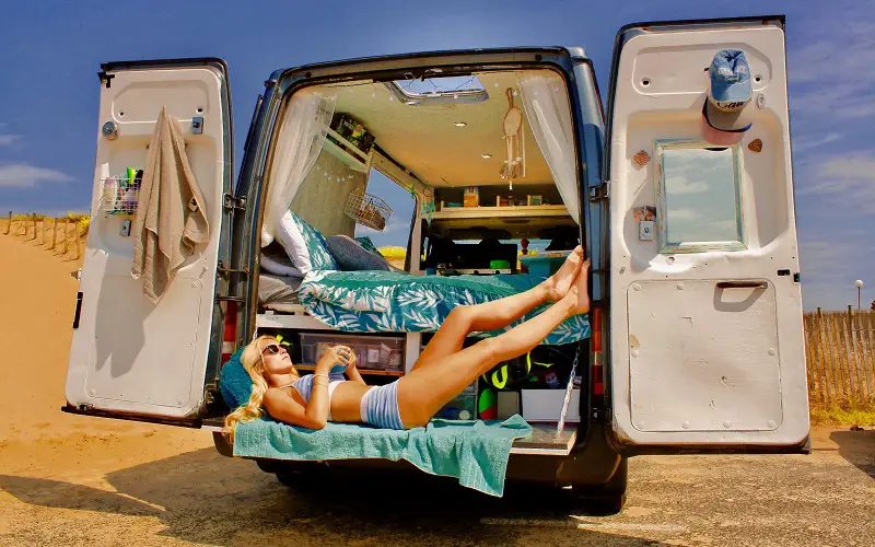 Girl lying inside van
